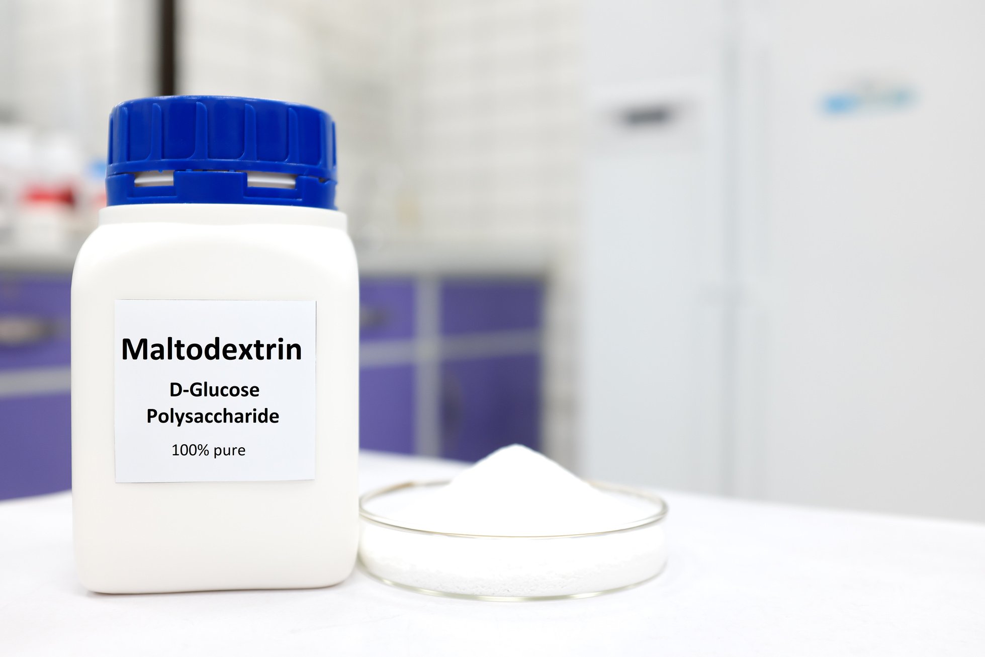 Selective focus of a bottle of pure maltodextrin with powder in petri dish. White laboratory background with copy space.