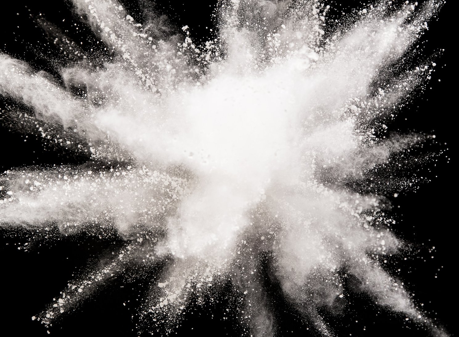 White powder explosion on black background.