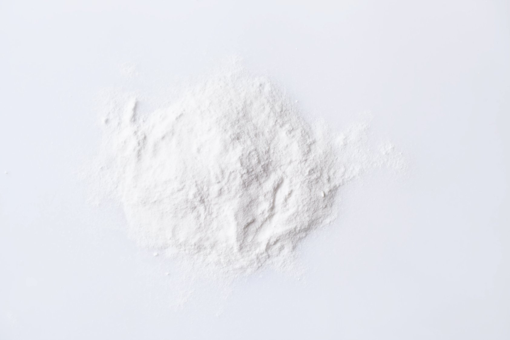 Pile of chemical white powder aspartame E951  on white